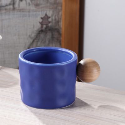 330ml Blue And White Ceramic Coffee Mug With Wooden Spherical Handle For Business Gifting